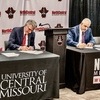 University of Central Missouri President Roger Best, left, and North Central Missouri College President Lenny Klaver sign ­documents making possible the new NCMC+UCM Direct Connect Transfer ­Agreement.