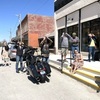 A group of local store owners, visitors, and interested folks watching the eclipse.