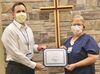 Kathi Tolly receives the Wright Memorial Hospital Employee of the Quarter Award for second quarter 2022 from Steve Schieber, CEO.